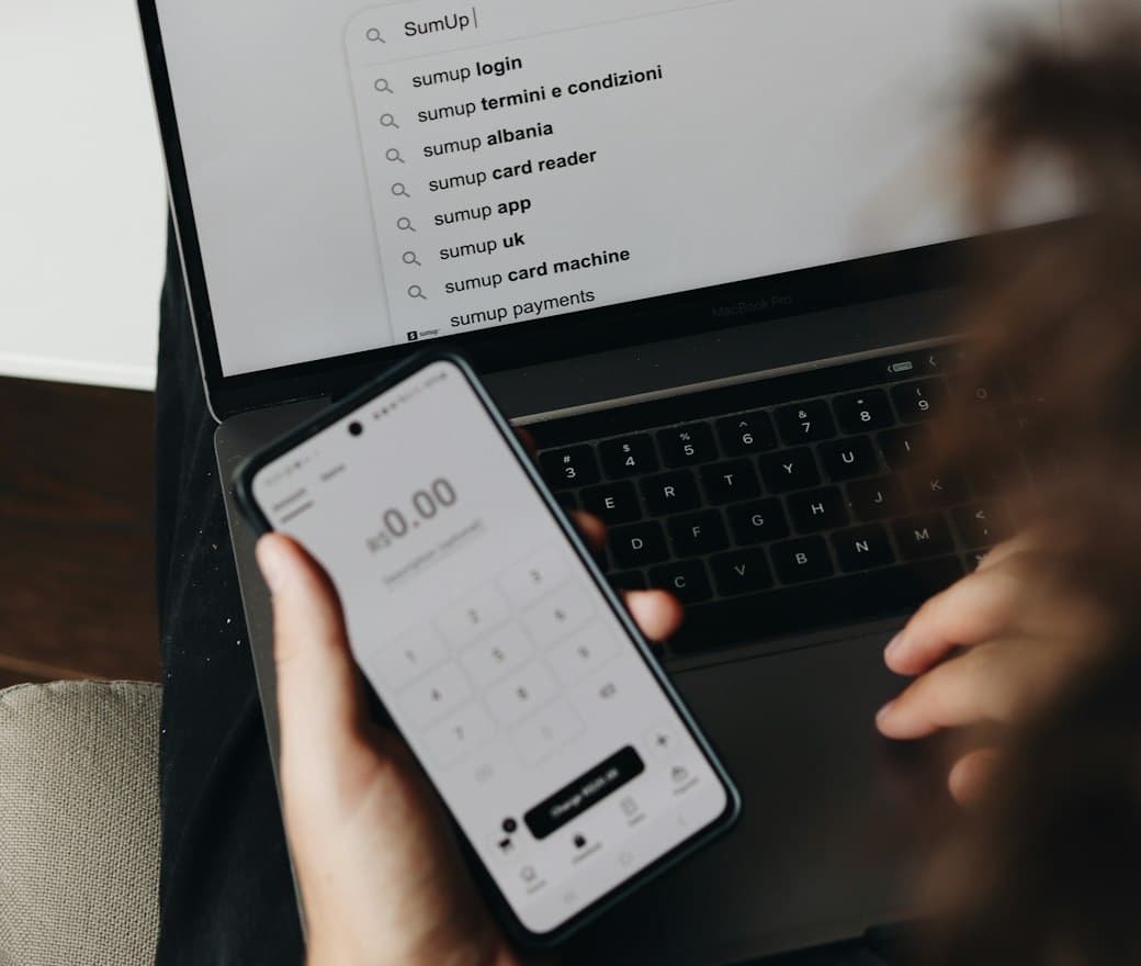 Checking SEO search results on a phone and laptop